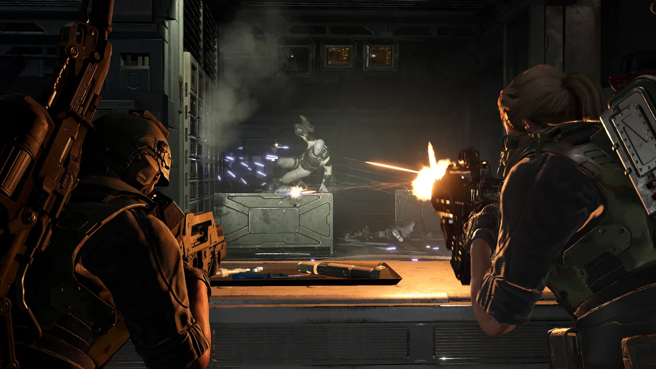 Aliens: Fireteam Elite 2 gameplay: two marines firing at xenomorphs flooding through a doorway, motion tracker visible