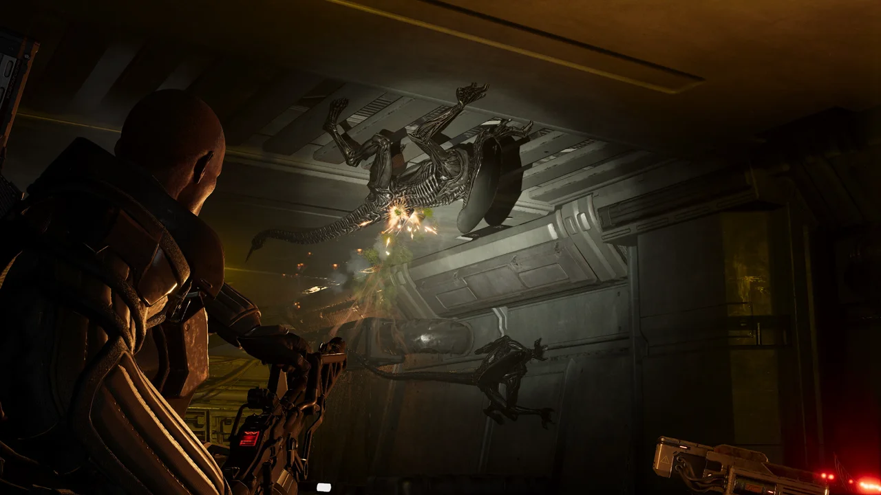 Aliens: Fireteam Elite 2 gameplay: a marine squad advancing through a hive-like alien structure with acid-green light