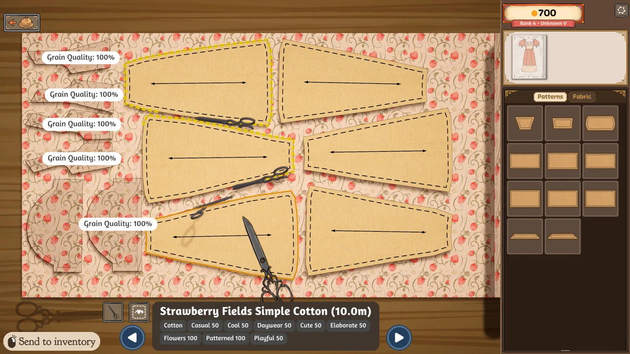 Dressmaker screenshot: the cutting table with a printed fabric bolt, paper pattern pieces and scissors