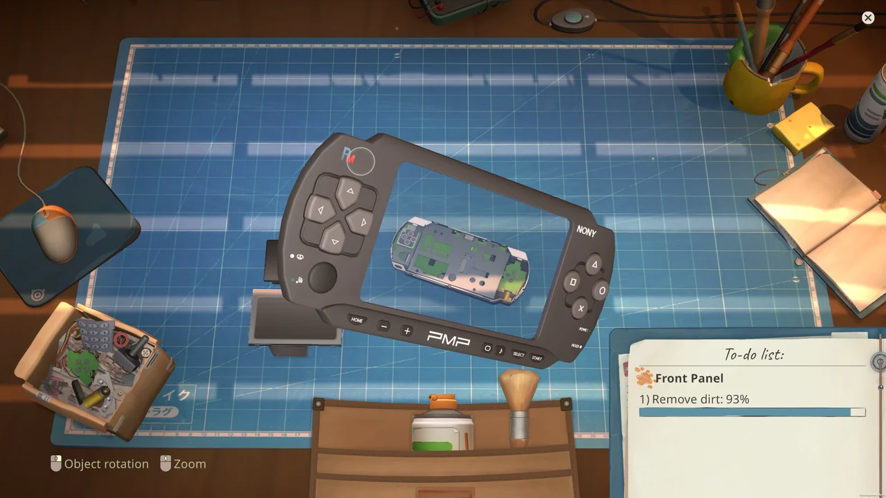 ReStory repair bench: cleaning the front panel of a handheld console on a blue cutting mat, with a to-do list UI