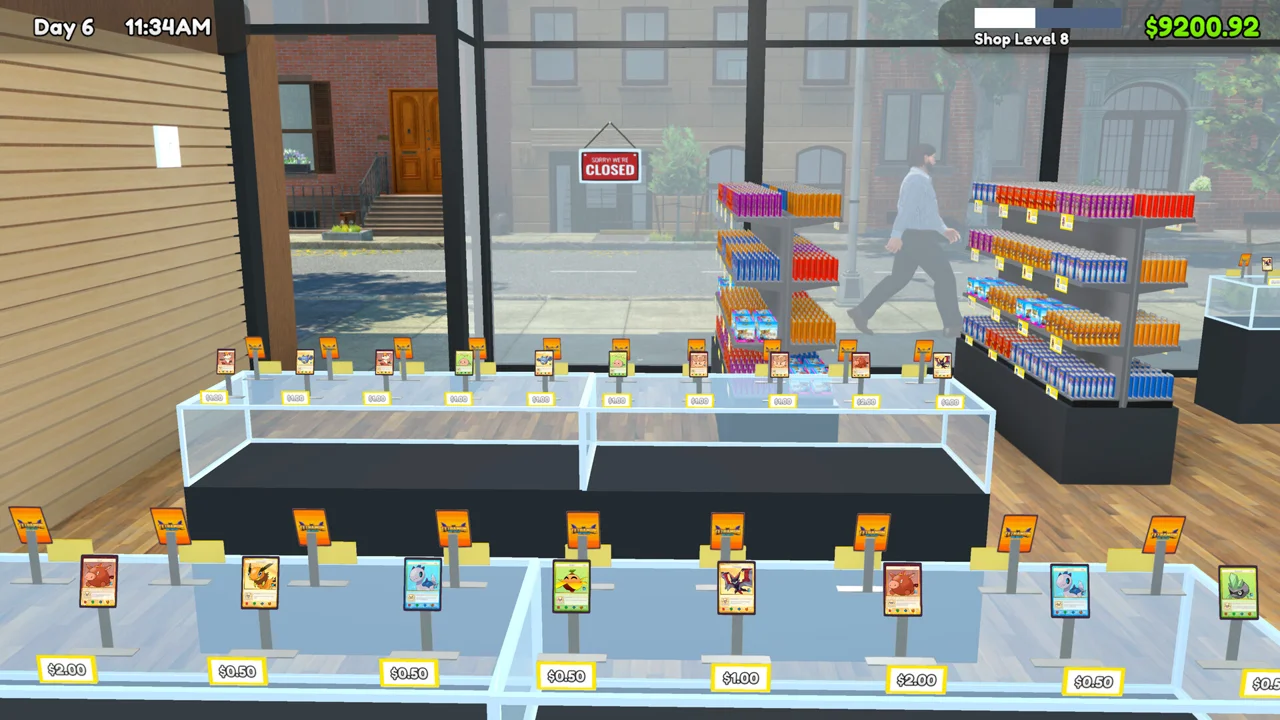 TCG Card Shop Simulator: view from behind the shop counter out through the storefront window, shelves of card products inside and a street outside, Sorry We're Closed sign on the door